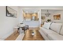 Bright living room featuring stylish furniture, wood floors, and an open layout to the modern kitchen at 9708 E Via Linda Rd # 1350, Scottsdale, AZ 85258