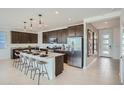 Modern kitchen with a large island, stainless steel appliances, and dark wood cabinetry at 10132 E Ursula Ave, Mesa, AZ 85212