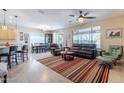 Open-concept living room with tile flooring, neutral tones, and plenty of natural light at 102 W Raven Dr, Chandler, AZ 85286