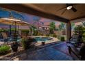 Inviting backyard pool with covered patio, perfect for outdoor entertaining and relaxation at 102 W Raven Dr, Chandler, AZ 85286