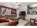 Cozy living room featuring a fireplace, ceiling fan and stylish furnishings at 11375 E Sahuaro Dr # 1062, Scottsdale, AZ 85259