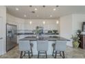 Spacious kitchen features a large island, stainless steel appliances, and modern lighting fixtures at 11470 E Yeager Cyn, Gold Canyon, AZ 85118