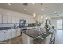 Bright kitchen with white cabinetry, granite countertops, stainless steel appliances, and pendant lights at 11470 E Yeager Cyn, Gold Canyon, AZ 85118