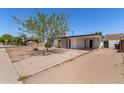 Single-story home featuring a covered parking and a desert landscape at 12453 N 29Th Ave, Phoenix, AZ 85029