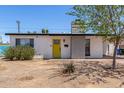 Single-story home featuring a bright yellow front door and a low maintenance landscape at 12453 N 29Th Ave, Phoenix, AZ 85029