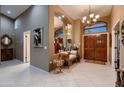 Grand foyer featuring tile flooring, high ceilings, and elegant chandelier at 12754 E Laurel Ln, Scottsdale, AZ 85259