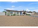 Single-story home showcasing desert landscaping, a blue walkway, and arched entrance at 12826 N 29Th St, Phoenix, AZ 85032