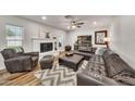 Bright living room with a leather sectional, white brick fireplace, and modern decor at 12826 N 29Th St, Phoenix, AZ 85032