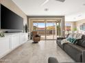 Open-concept living room with a slider door leading to the patio and desert views at 13406 W Rowel Rd, Peoria, AZ 85383