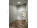 Open bedroom with tile flooring, light gray walls, and white door to the rest of the home at 14002 N 49Th Ave # 1120, Glendale, AZ 85306