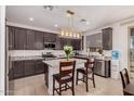 Modern kitchen features granite countertops, stainless steel appliances, and a stylish island at 14253 W El Cortez Pl, Surprise, AZ 85387
