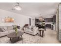 Inviting living room with neutral tones and an open layout, perfect for entertaining at 14253 W El Cortez Pl, Surprise, AZ 85387