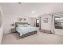 Spacious main bedroom featuring plush carpet, plenty of natural light, and calming decor at 14253 W El Cortez Pl, Surprise, AZ 85387