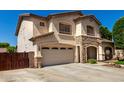 Two-story stucco home with stone accents, attached garage and large driveway at 14604 W Banff Ln, Surprise, AZ 85379