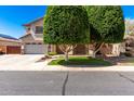 Charming two-story home boasts a landscaped yard and attached two-car garage at 14604 W Banff Ln, Surprise, AZ 85379