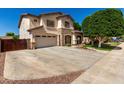 Two-story stucco home with stone accents, attached garage and extended driveway at 14604 W Banff Ln, Surprise, AZ 85379