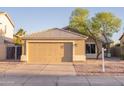 Inviting single-Gathering home featuring a neutral color palette, desert landscaping, and an attached two car garage at 15067 W Taylor St, Goodyear, AZ 85338