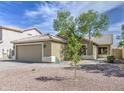 Inviting single-Gathering home featuring a neutral color palette, desert landscaping, and an attached two car garage at 15067 W Taylor St, Goodyear, AZ 85338