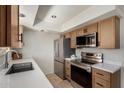 Modern kitchen with stainless steel appliances, white countertops and tile floor at 16336 E Palisades Blvd # 4, Fountain Hills, AZ 85268