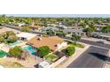 An aerial view of a single-Gathering home with a backyard swimming pool, putting green, and desert landscaping at 1704 E Hackamore St, Mesa, AZ 85203