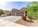 Charming single-story home with a three-car garage and well-maintained desert landscaping at 1736 E Joelle Dr, Casa Grande, AZ 85122