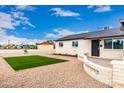 Single-story home with manicured front yard, gravel landscaping, and modern turf at 1852 N Grand St, Mesa, AZ 85201