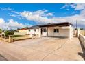 Single-story home featuring a covered parking area, gravel yard, and desert landscaping at 1852 N Grand St, Mesa, AZ 85201