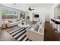 Bright living room featuring hardwood floors, neutral décor, and lots of natural light at 19973 E Thornton Rd, Queen Creek, AZ 85142