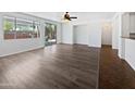 Spacious living room with hardwood floors, a ceiling fan, and a sliding glass door at 19973 E Thornton Rd, Queen Creek, AZ 85142