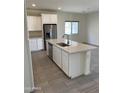 Bright kitchen showcasing a center island, stainless steel appliances, and ample counter space at 2181 N 211Th Dr, Buckeye, AZ 85396