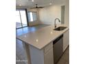 Open-concept kitchen and living area with a granite countertop, stainless steel dishwasher, and a ceiling fan at 2181 N 211Th Dr, Buckeye, AZ 85396