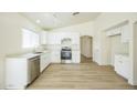 Bright kitchen featuring white cabinets, stainless steel appliances, and modern countertops at 22010 W Solano Dr, Buckeye, AZ 85326