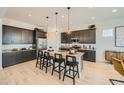 Modern kitchen with an island, pendant lighting, and stainless steel appliances at 23134 E Nightingale Rd, Queen Creek, AZ 85142
