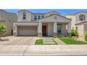 Charming two-story home featuring a well-manicured front yard, covered entryway, and a spacious two-car garage at 24314 N 21St Pl, Phoenix, AZ 85024