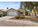 Charming single-story home featuring a two-car garage and low maintenance desert landscaping at 2625 E Beverly Rd, Phoenix, AZ 85042