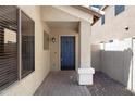 Inviting front porch with a blue door and brick flooring at 2625 E Beverly Rd, Phoenix, AZ 85042