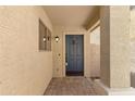 Inviting front entryway featuring a blue door, brick flooring and covered porch at 2625 E Beverly Rd, Phoenix, AZ 85042