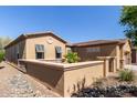 Single-story home featuring shuttered windows and a quaint courtyard with desert landscaping at 29159 N 128Th Ln, Peoria, AZ 85383