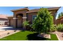View of a landscaped front yard featuring vibrant artificial turf and desert landscaping for low maintenance at 3081 E Desert Broom Pl, Chandler, AZ 85286