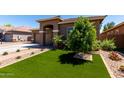 View of a landscaped front yard featuring vibrant artificial turf and desert landscaping for low maintenance at 3081 E Desert Broom Pl, Chandler, AZ 85286