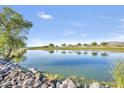 Scenic pond with blue water reflecting the sky and trees at a golf course community at 33575 N Dove Lakes Dr # 2033, Cave Creek, AZ 85331