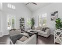 Bright living room with high ceilings, plantation shutters, and stylish furnishings, creating an inviting atmosphere at 3514 E Desert Broom E Way, Phoenix, AZ 85044