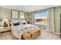 Cozy bedroom with a large window, neutral décor, and stylish accents, creating a serene retreat at 36620 W Maddaloni Ave, Maricopa, AZ 85138