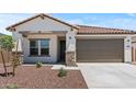 Beautiful single-Gathering home with a well-manicured front yard and a two-car garage at 3913 S 233Rd Ln, Buckeye, AZ 85326