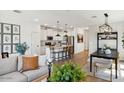 Open-concept living space with kitchen, dining, and living areas with lots of natural light at 3913 S 233Rd Ln, Buckeye, AZ 85326