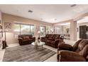 Comfortable living room with plush seating, a neutral color palette, and views to outdoor patio at 41638 N Emerald Lake Dr, Anthem, AZ 85086