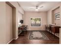Cozy office space with wood flooring, a modern desk, and a large window offering ample natural light at 41638 N Emerald Lake Dr, Anthem, AZ 85086