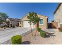 Beige single story home with an attached garage, landscaped front yard and a concrete driveway at 4514 W Hazel Ln, San Tan Valley, AZ 85144