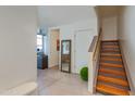 Inviting entryway with wooden stairs, a modern mirror, and a glimpse into the stylish living space at 4747 N Scottsdale Rd # 4009, Scottsdale, AZ 85251