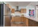Modern kitchen featuring stainless steel appliances, light wood cabinets, and elegant countertops at 4747 N Scottsdale Rd # 4009, Scottsdale, AZ 85251